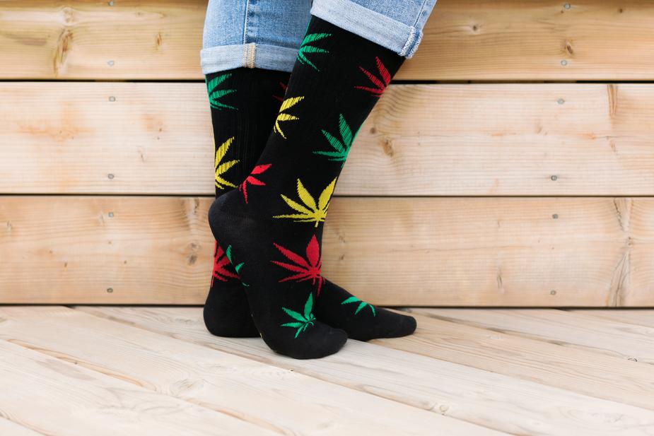 Socks with marijuana plant print shapes in red, green and yellow.